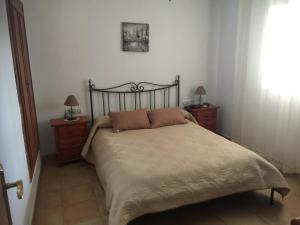 a bedroom with a large bed with two night stands at Vista al Mar Ylenia in Almería