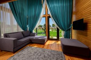 a living room with a couch and a large window at Villa d'Mare in Demre