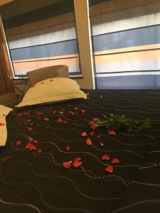 a bedroom with a bed with red flowers on it at Hotel Feel Inn Venice Airport Rooms in Campalto