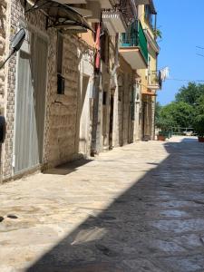 an empty street in a building with a shadow on the ground at B&B Casa AMALIA in Barletta