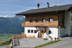 a house with a large patio in front of it at Bio-Bergbauernhof Hubgut in Zell am See