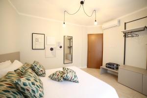 a bedroom with a bed with two pillows on it at Casa Ercoli Abbadia in Abbadia di Montepulciano