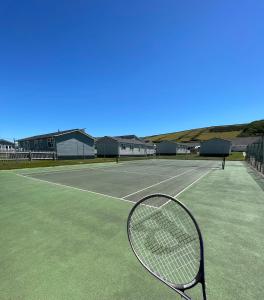 a tennis racket sitting on a tennis court at Croyde Bay Hotel or Self Catering in Croyde