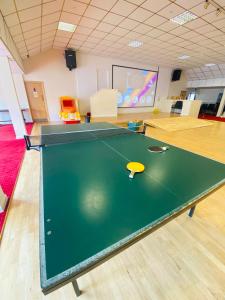 a ping pong table with a toy car on top of it at Croyde Bay Hotel or Self Catering in Croyde
