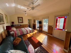 a living room with a couch and a table at The Dairy Cottage - Lake Lorne - Drysdale in Drysdale