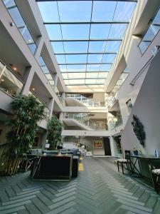 an empty lobby with a large skylight in a building at Casa do Adro Hotel in Ferreira do Zêzere