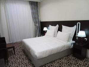 Kama o mga kama sa kuwarto sa Abdul Hafez Al Humaidan Hotel