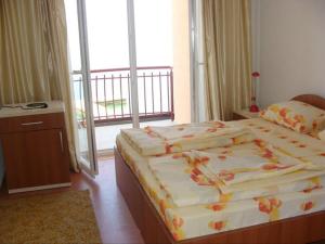 a bedroom with two beds and a balcony at Villa Cvet Rooms in Ohrid +9 photos