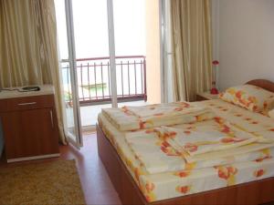 a bedroom with two beds and a balcony at Villa Cvet Rooms in Ohrid
