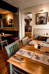 a dining room with a wooden table and chairs at Stables Ashbourne in Ashbourne