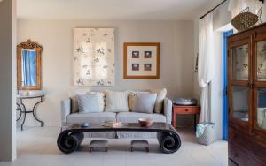a living room with a couch and a coffee table at Absolute Perdika Aegina in Perdika