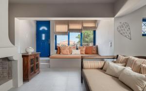 a living room with a couch and a bed at Absolute Perdika Aegina in Perdika