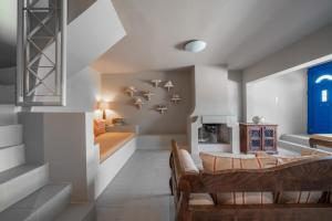 a living room with a couch and a fireplace at Absolute Perdika Aegina in Perdika