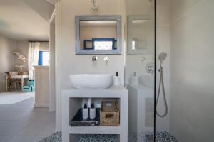 a bathroom with a sink and a shower at Absolute Perdika Aegina in Perdika