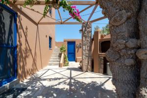 a hallway of a building with a blue door at Absolute Perdika Aegina in Perdika