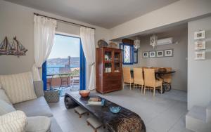 a living room with a couch and a table at Absolute Perdika Aegina in Perdika