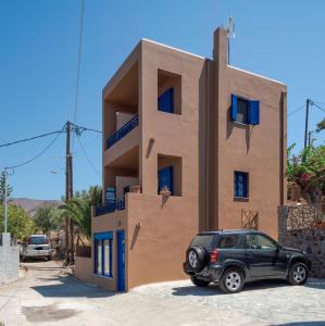 a car parked in front of a house at Absolute Perdika Aegina in Perdika