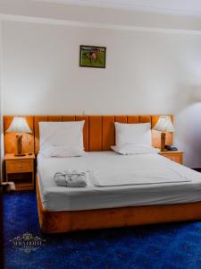 a bedroom with a large bed with two night stands at Afra Oghuz Mountain Resort Hotel in Oğuz