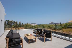 a patio with furniture and a view of the ocean at Horizon Luxury Villa in Chania Town +42 photos