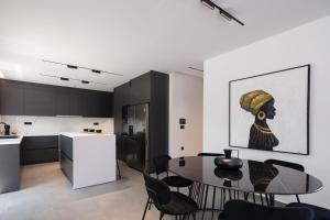 a kitchen and dining room with a table and chairs at Horizon Luxury Villa in Chania Town