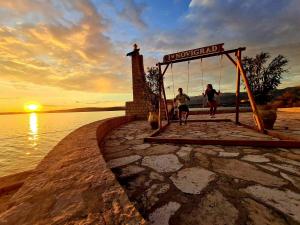 two people running on the beach at sunset at Apartments Mali Dvor Novigrad in Novigrad Dalmatia