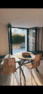 una mesa y sillas en una habitación con patio en Grande maison familiale, Concarneau, en Trégunc