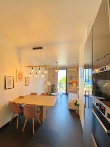 a dining room and living room with a table and chairs at Appartement Nice Promenade in Nice