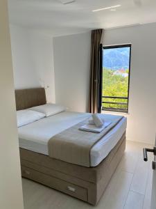 a bedroom with a bed with a large window at Zen Residence in Brist