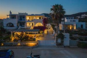 a house with a palm tree in front of it at KAMEO, Antiparos in Antiparos