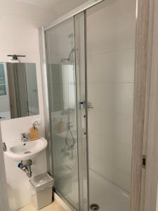 a bathroom with a glass shower and a sink at Sweet life La spezia Liguria in La Spezia +24 photos