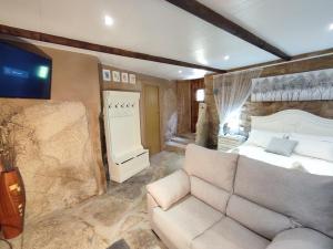 a living room with a bed and a couch at A Cuadriña in Mazaricos