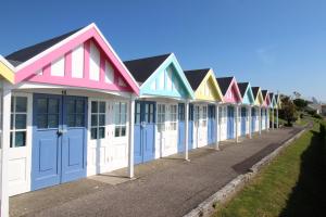 a row of colourful beach houses on a street at 7 Harbour Reach in Weymouth