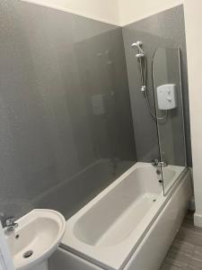 a bathroom with a sink and a tub and a toilet at Liley Apartments in Stockton-on-Tees