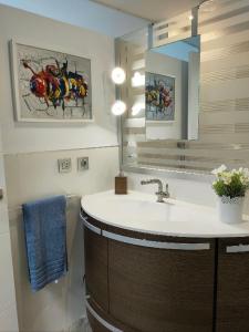uma casa de banho com um lavatório e um espelho em Casa Maga em Maspalomas