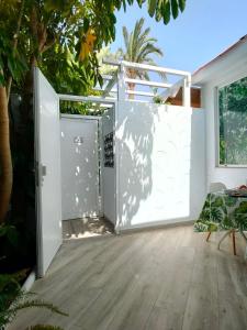an open door leading to a patio with trees at Casa Maga in Maspalomas