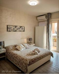 Postel nebo postele na pokoji v ubytování B&B La Palmetta