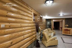 a lobby with a wooden wall with chairs and a waiting room at Tatrzański Gościniec in Leśnica