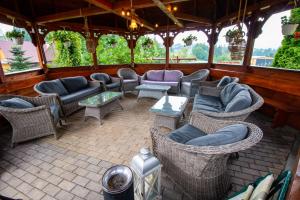 an outdoor patio with couches and chairs and tables at Tatrzański Gościniec in Leśnica