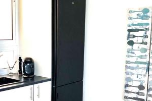 a black refrigerator in a kitchen next to a counter at MIRADOR DE MERESE in Frontera