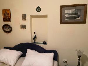 a living room with a couch and a clock on the wall at Seaside dream in Trstenik