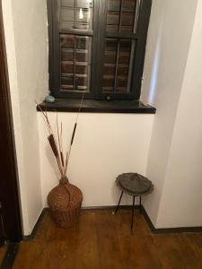 a room with a window and a basket and a stool at Seaside dream in Trstenik