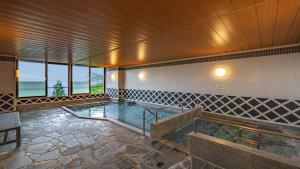 a large swimming pool in the middle of a building at KAMENOI HOTEL Atami Annex in Atami
