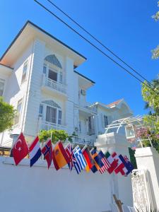 a line of flags hanging in front of a house at Ikigai Hotel Villa Rıfat in Adalar