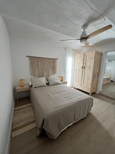 ein Schlafzimmer mit einem großen Bett und einem Deckenventilator in der Unterkunft Apartamentos Buganvilla Roquetas de Mar in Roquetas de Mar