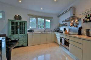 a large kitchen with a sink and a stove at Luxury Villa In Es Cubells With Stunning Seaviews in Es Cubells