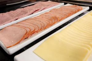 a tray of different types of cheese and meats at ibis Betim in Betim