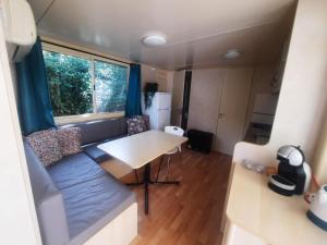 a small living room with a table and a couch at casavistafiore in Montefiore dellʼAso