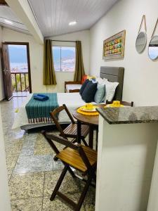 a living room with a couch and a table at Flat vista incrível in Arraial do Cabo