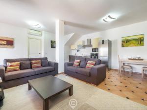 a living room with two couches and a table at House Federica in Villasimius +22 photos