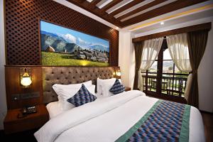 a bedroom with a large bed and a window at Everest Boutique Hotel in Kathmandu